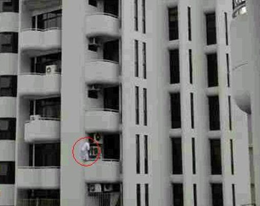 circled man up high on balanced on a balcony
