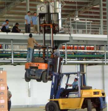 Forklift balanced on another forklift