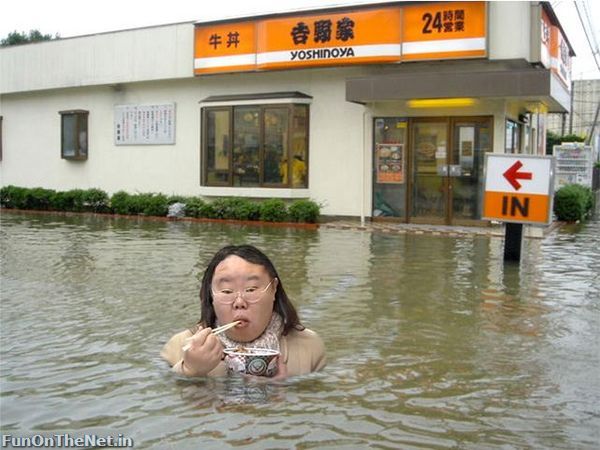 women in flood eating noodles