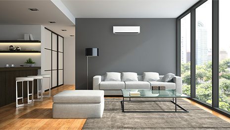 White Wall-Mounted Air conditioning unit in a modern lounge